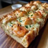 Käse-Seafood-Brot Rezept Zutaten: - 1 Baguette - 200 g Meeresfrüchte (z. B. Garnelen, Muscheln) - 150 g Frischkäse - 100 g geriebener Käse (z. B. Mozzarella) - 2 Knoblauchzehen - 2 EL Petersilie - 1 EL Zitronensaft - Salz und Pfeffer nach Geschmack Anleitung: 1. Ofen auf 180°C vorheizen. 2. Baguette längs aufschneiden. 3. Knoblauch hacken und mit Frischkäse, Meeresfrüchten, Zitronensaft, Petersilie, Salz und Pfeffer vermischen. 4. Die Mischung auf die Brothälften verteilen und mit geriebenem Käse bestreuen. 5. Brot auf ein Backblech legen und 10-15 Minuten backen, bis der Käse goldbraun und geschmolzen ist. 6. In Stücke schneiden und servieren.