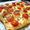 Focaccia with herbs and tomatoes